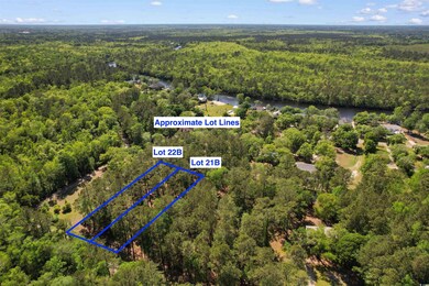Aerial view featuring a wooded view