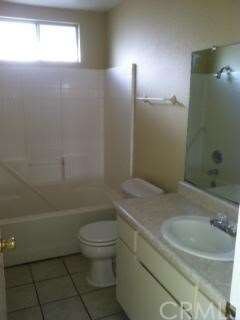 Large Bathroom with Shower over Tub.