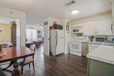 Kitchen featuring white cabinetry, white appliance