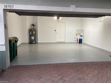 Garage with a garage door opener and electric water heater