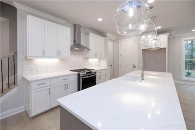 The kitchen features quartz countertops, GE Profil