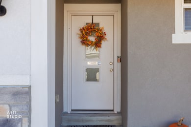 View of exterior entry featuring stucco siding