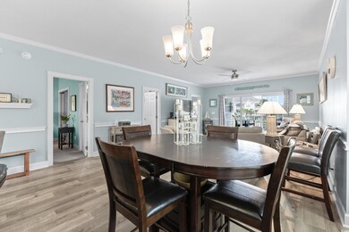 Dining area with ornamental molding, light wood-ty