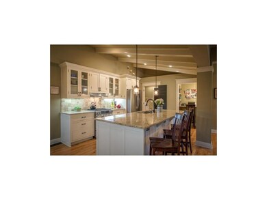 Large, bright kitchen with huge island, gas range 