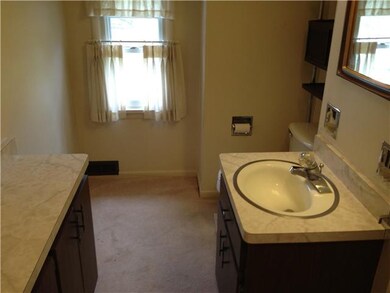 Bathroom. This upstairs half-bath includes two van