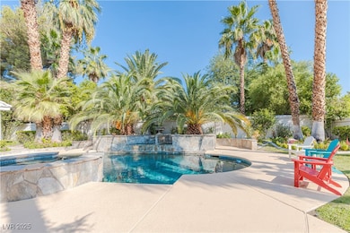 Outdoor pool with a patio area and fence