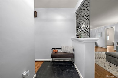 Hallway featuring baseboards and dark wood-style flooring