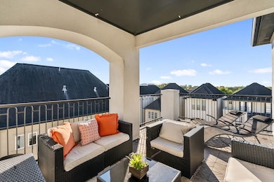 Fabulous expansive fourth-floor rooftop terrace featuring black iron railing, recessed lighting, electrical outlets, and water connections. Offers both covered and open areas with plenty of room for outdoor furniture and a grill—perfect for entertaining or relaxing year-round.