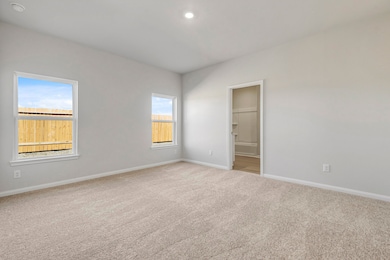 The primary bedroom has beautiful windows that let