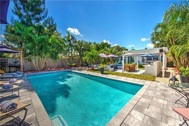 View of pool with exterior bar and a patio