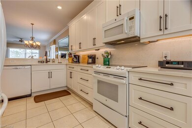Kitchen featuring white appliances, sink, ornament