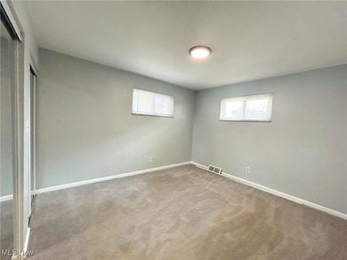 Spare room with carpet floors and baseboards