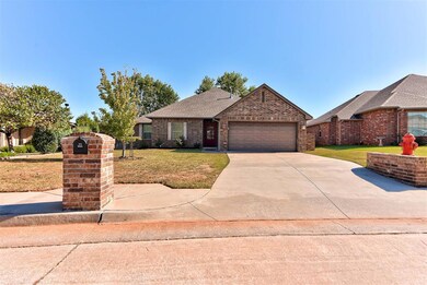 View of front of home with a front lawn, driveway, brick siding, roof with shingles, and a garage