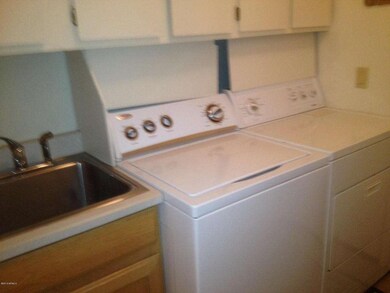 Laundry room with sink and cabinets