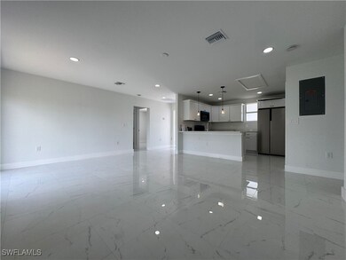 Unfurnished living room with light marble finish f