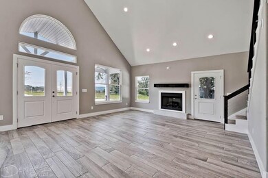 High end wood look tile flooring, gas log fireplace, lots of recessed lighting, wired for surround sound, double front entry doors, high ceilings, open, light, airy and beautiful.