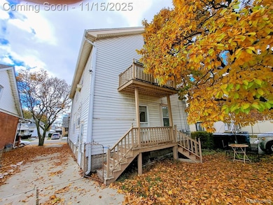 Back of property with a balcony