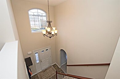 SOARING 2 STORY FORYER WITH BRONZE CHANDELIER.