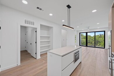 Kitchen with white cabinetry, built in shelves, l