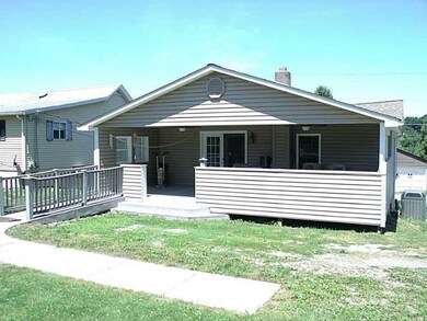 Exterior Back. Relax on the covered rear porch wit