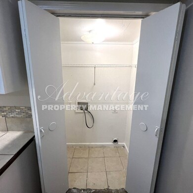 Clothes washing area featuring hookup for a washin