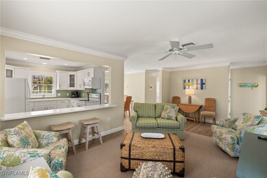 Living area featuring crown molding, visible vents