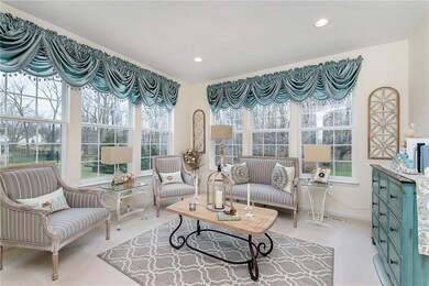The sunroom's windows allow natural light to pour into the space
