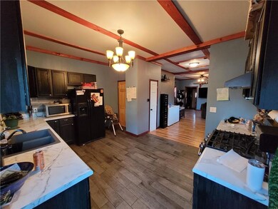 Kitchen nicely updated with tile backsplash and ti