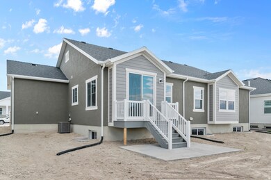 Back of property featuring roof with shingles and a patio