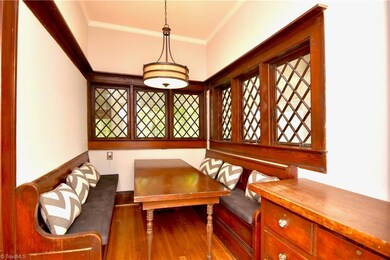 Breakfast nook with amazing diamond mutin casement windows and builtin benches and serving chest.