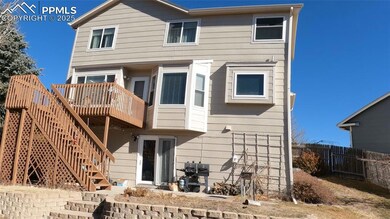 Back of property with a wooden deck