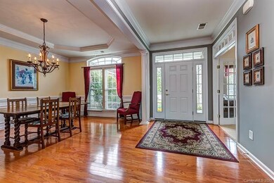 Bright entry with hardwood floors is open to Forma