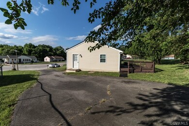 View of property exterior featuring a deck and a yard