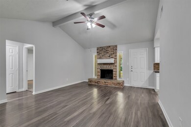 The den features a fireplace and direct access to