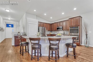 Open kitchen with breakfast bar, granite counters, smart appliances, touchless sink faucet