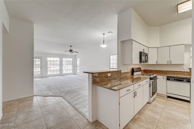 Kitchen featuring visible vents, gas stove, white