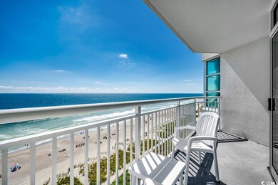 Balcony featuring a water view and a beach view