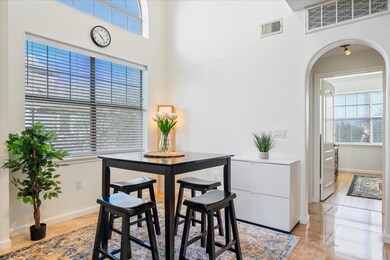Dining space featuring visible vents, arched walk
