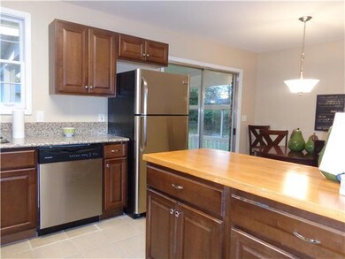 Beautiful granite counters shows off  this kitchen and the  island with a bamboo wood top has serving space for you and your family. 