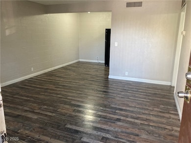 Living room with dark wood-type flooring
