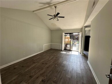 Unfurnished living room featuring dark wood-style floors and ceiling fan