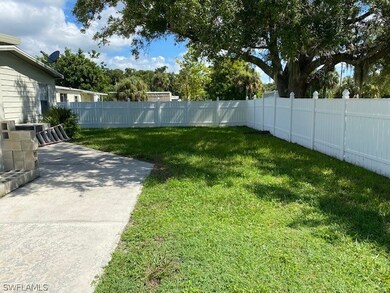 East side yard adjacent to patio. Vinyl fencing and a great shade tree