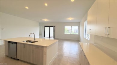 Kitchen featuring open floor plan, recessed lighting, stainless steel dishwasher, an island with sink, and modern cabinets
