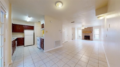 Kitchen with light tile patterned floors, white ap