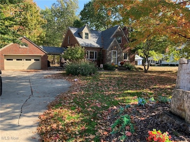 View of front facade featuring concrete driveway and a garage