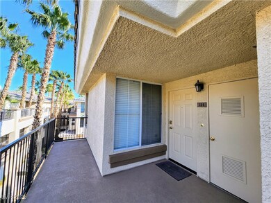 Entrance to property with stucco siding and a balc