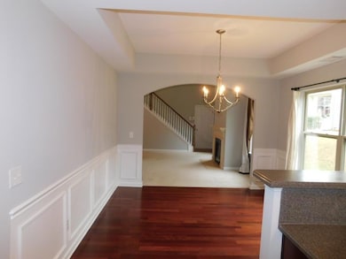 Unfurnished dining area featuring a decorative wal