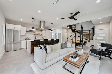 Living area with recessed lighting, ceiling fan, 