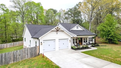 View of front of property with driveway, roof with