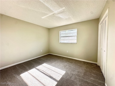Unfurnished bedroom featuring a textured ceiling,